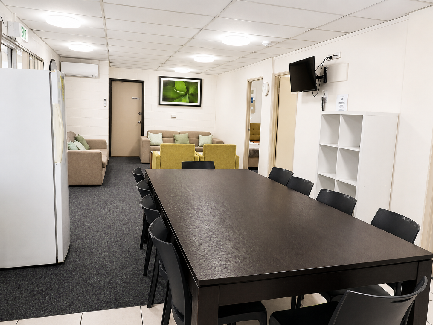 Modern office room with a long table and chairs.